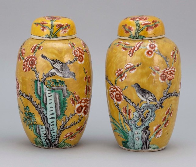 PAIR OF CHINESE FAMILLE ROSE PORCELAIN COVERED GINGER JARS Decorated with nightingales on flowering tree branches against a mustard...