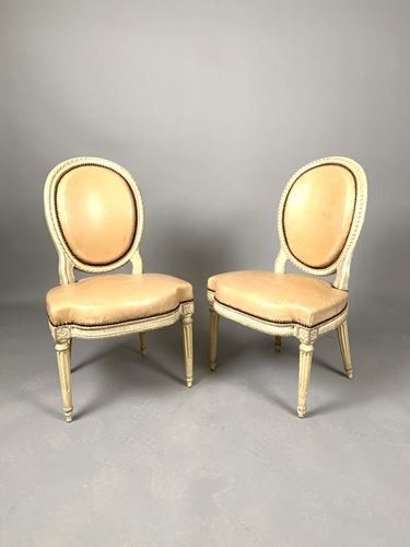 Pair of carved and cream lacquered wooden chairs...