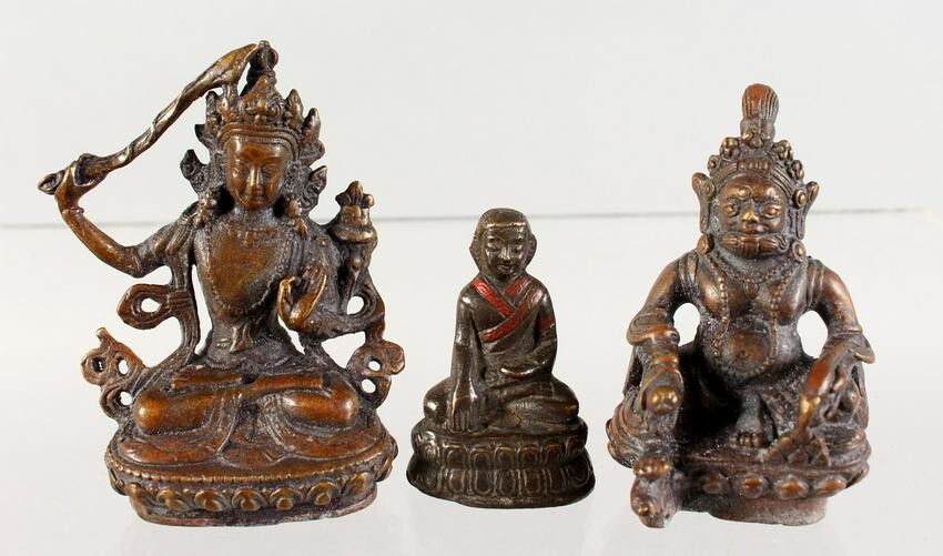 THREE SMALL BRONZE FIGURES OF SEATED BUDDHAS. 3ins