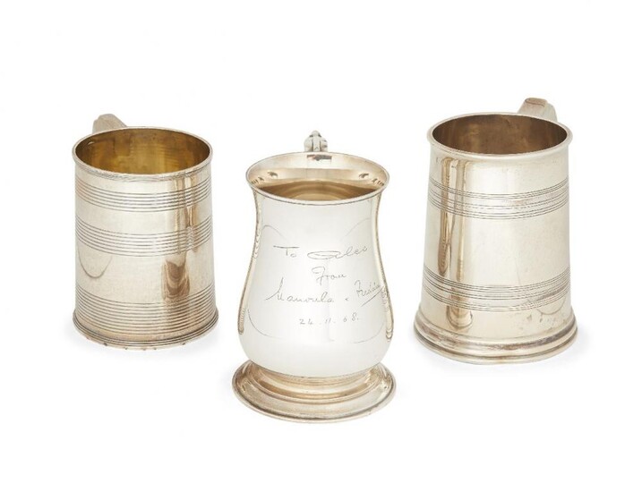 Three silver tankards, two with reeded decoration,...