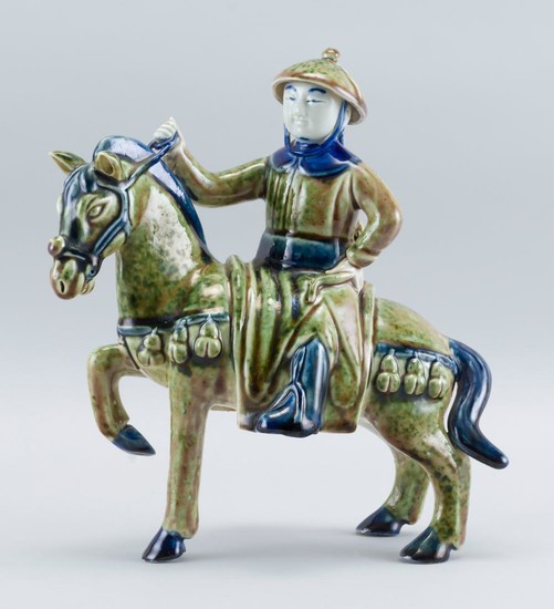 UNUSUAL CHINESE PEACHBLOOM GLAZE PORCELAIN FIGURE In the form of a rider on horseback. Length 9.5".