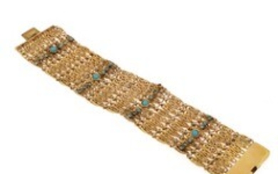 1927/1127 - A turquise bracelet set with numerous cabochon turquises, mounted in 18k gold. W. 3.2 cm. L. 18 cm. Weight app. 49.5 g.