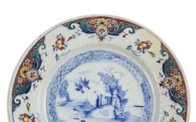 27-Delft: a large dish decorated with a biblical landscape painted...