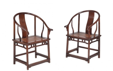 A pair of Chinese hardwood horseshoe-back armchairs
