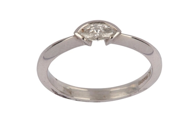 A diamond single-stone ring The marquise-cut diamond horizontally-set...