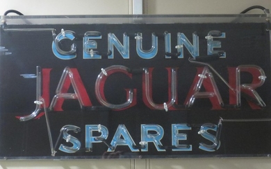 A "Genuine Jaguar Spares" neon advertising sign
