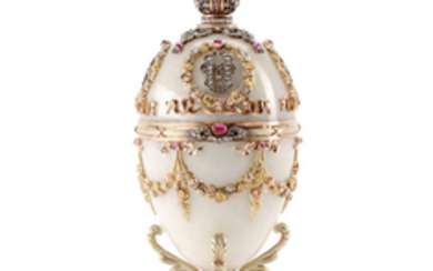 A Russian 14K Gold, Silver, Diamond, Guilloche Enamel, White Hardstone, and Moonstone and Ruby Cabochon-Mounted Egg on matching stand