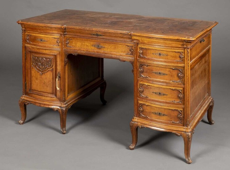 Desk. A Continental walnut and figured walnut Rococo style kneehole desk, circa 1900