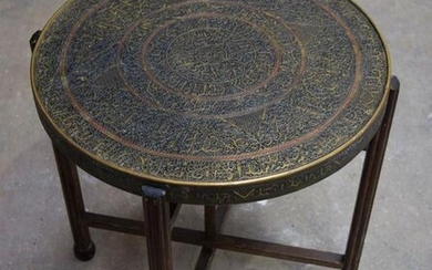 A 19th Century Islamic repoussé brass table fitted with
