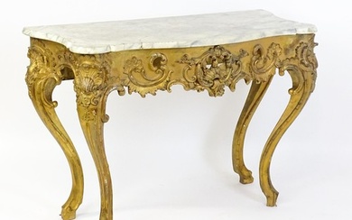 A 19thC marble topped table with a gesso and giltwood moulde...