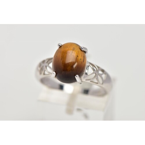 A 9CT WHITE GOLD, TIGER EYE SET RING, designed with an oval ...