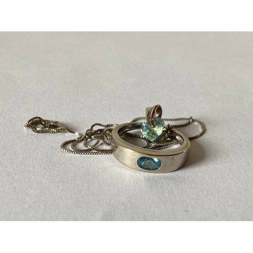 A 9ct white gold ring, set with an oval blue topaz and a whi...