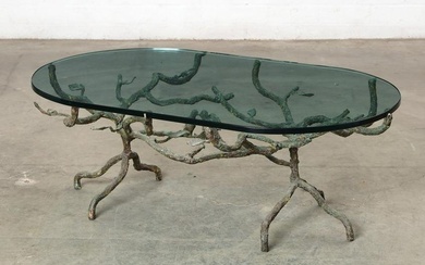 A Brutalist patinated iron and glass coffee table