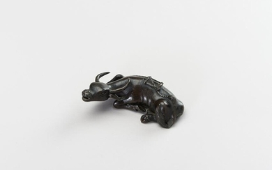 A CHINESE BRONZE FIGURE OF A TAMED WATER BUFFALO