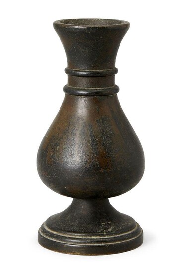 A Chinese bronze vase, 17th century, cast with a bulbous, pear-shaped body and two collar bands encircling the slim neck, all resting on a spreading stepped foot, 18 cm high