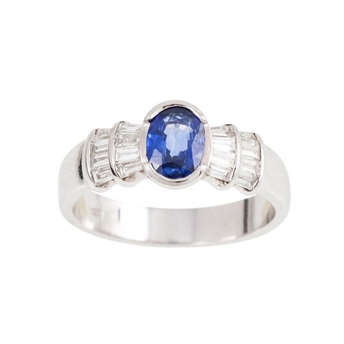 A DIAMOND AND SAPPHIRE DRESS RING, the oval sapphire to bagu...