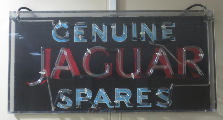 A "Genuine Jaguar Spares" neon advertising sign
