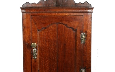 A George II oak corner cupboard, circa 1750 The back board...