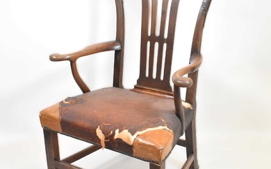 A George III oak armchair with yoke-shaped top rail, pierced...