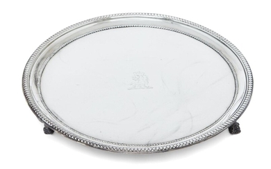 A George III silver waiter, London, 1782, Robert Jones I, of circular form with beaded border and engraved lion crest to centre, raised on three claw and ball feet, 20.4cm dia., approx. weight 12.7oz