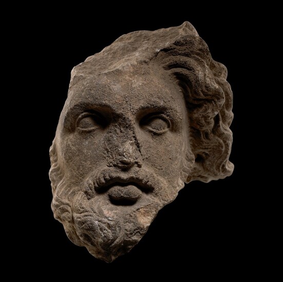 A HELLENISTIC MARBLE HEAD OF A BEARDED GOD, CIRCA 3RD CENTURY B.C.