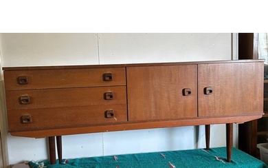 A Mid Century teak sideboard, three drawers and a two door c...