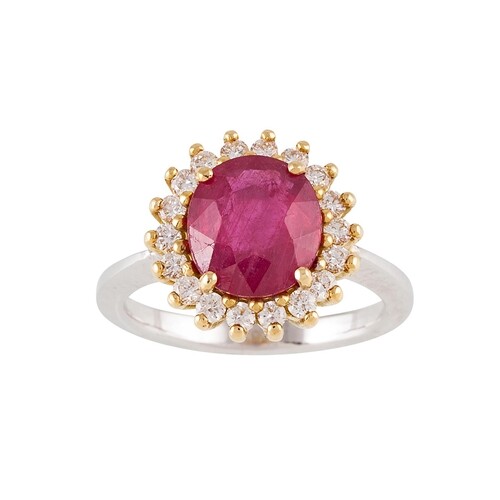 A RUBY AND DIAMOND CLUSTER RING, the oval ruby to a brillian...
