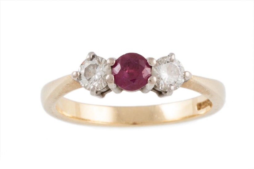 A RUBY AND DIAMOND THREE STONE RING mounted in 18ct yellow a...