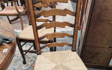 A SET OF SIX OAK LADDER BACK CHAIRS WITH RUSH DROP IN SEATS
