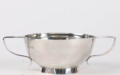 A SOLID SILVER ART DECO TWO HANDLED BOWL.
