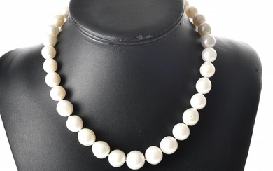 A STRAND OF SEMI BAROQUE SOUTH SEA PEARLS, GRADUATING IN SIZE 9.5MM TO 14.3MM TO A STERLING SILVER CLASP, TOTAL LENGTH 440MM