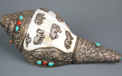 A Tibetan white metal decorated conch trumpet, L. 25cm.