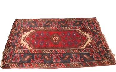 A Turkish hand knotted wool rug, in red, blue and ivory colo...