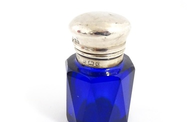 A blue glass scent / salts bottle with silver top hallmarked...