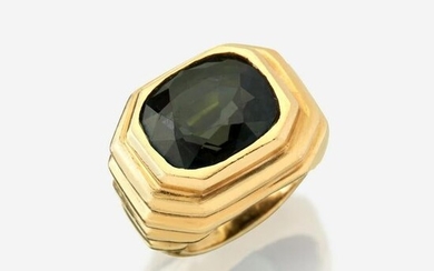A color change alexandrite and eighteen karat gold ring