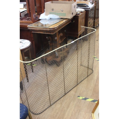 A large brass and mesh fender form fire guard, 124cm wide.
