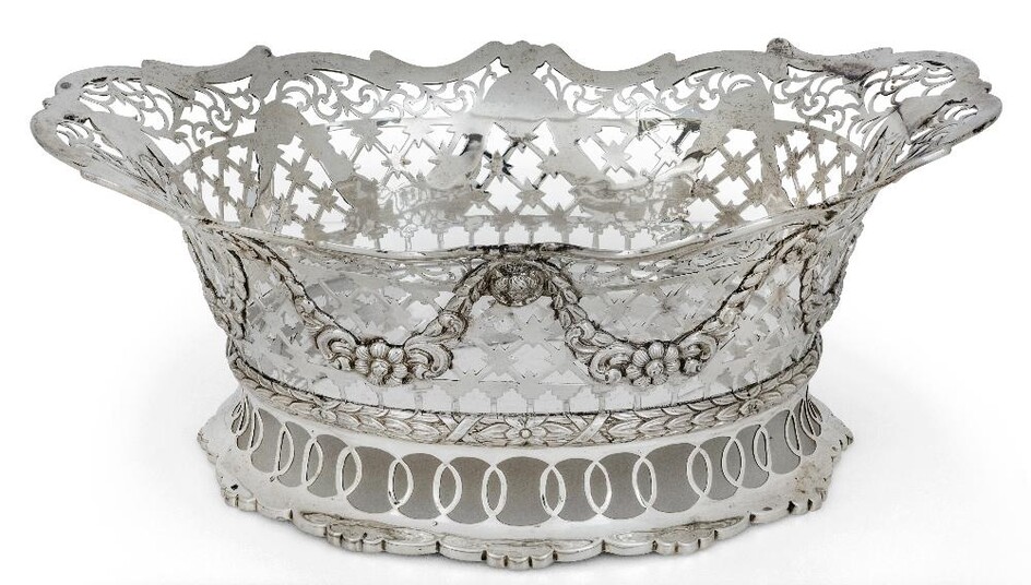 A late Victorian silver cake basket, London, 1899, Daniel & John Wellby, of shaped oval form, the pierced sides decorated with applied floral garlands to laurel wreath band above pierced shaped oval foot, 31cm long, 13.4cm high, approx. weight 38.5oz