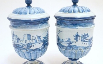 A pair of Continental blue and white pedestal jars and