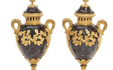 A pair of French Louis XVI style marble and gilt bronze vases...