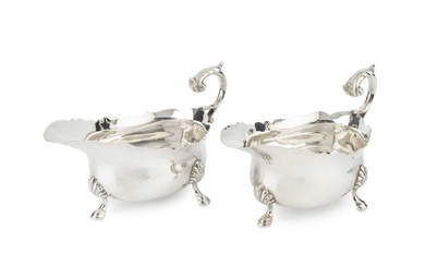 A pair of George V silver sauce boats, with shaped...