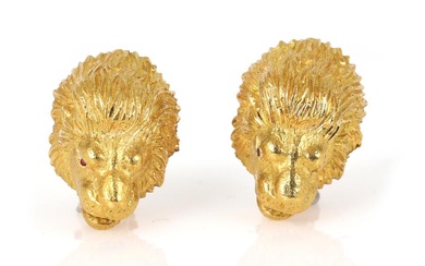 A pair of ear clips in the shape of lions heads, mounted...