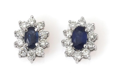A pair of ear studs each set with an oval-cut sapphire weighing...