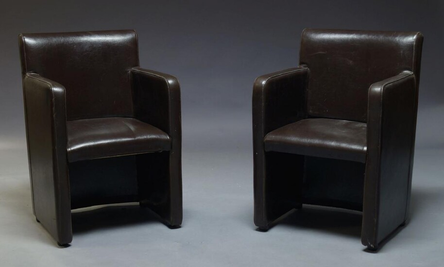 A pair of modern brown leather armchairs, of recent manufacture,...