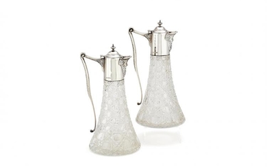 A pair of silver mounted cut glass claret jugs