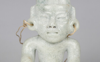 A pre-Columbian Teotihuacan style carved pale green hardstone figure of a seated ruler, probably 250