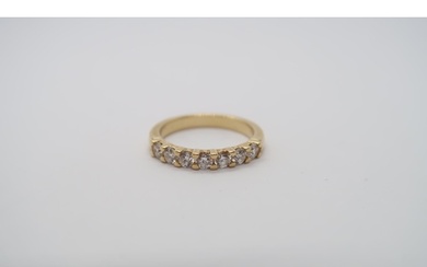 A seven stone diamond half eternity ring set in 18ct hallmar...
