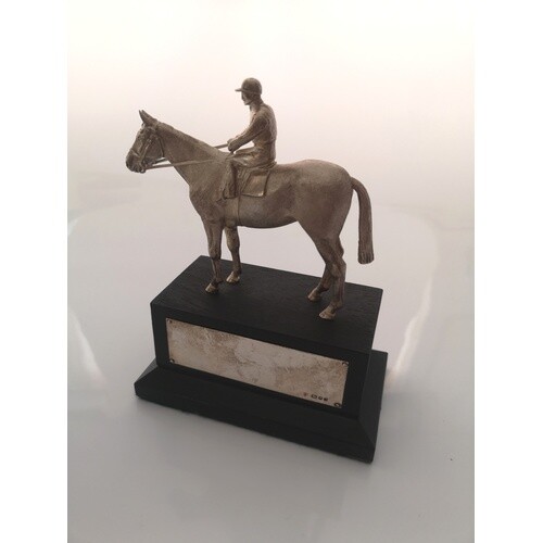 A sterling silver equestrian trophie. London 1983. On an ebo...