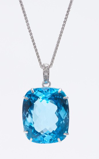 AN IMPRESSIVE TOPAZ PENDANT-The cushion cut blue topaz weighing 100cts, to a diamond set bale, suspended from a fine trace chain, al...