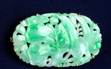 An Art Deco 18ct gold carved jade brooch.