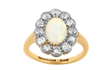 An Opal and Diamond Cluster Ring the oval opal within...